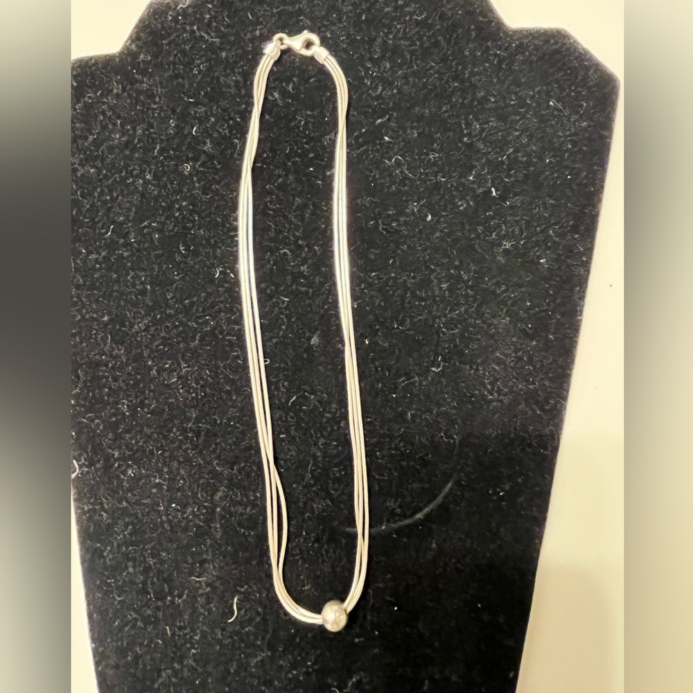 Sterling silver bead necklace with three strands.